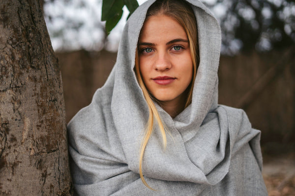 Storm grey baby alpaca throw worn as a wrap, close portrait