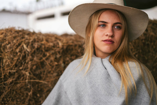 Storm grey alpaca throw over the shoulders, portrait in a hacienda yard