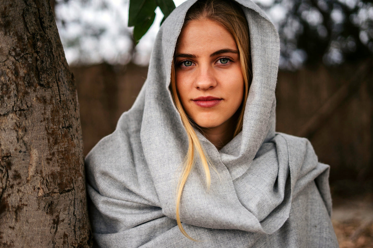 Storm grey baby alpaca throw worn as a wrap, close portrait
